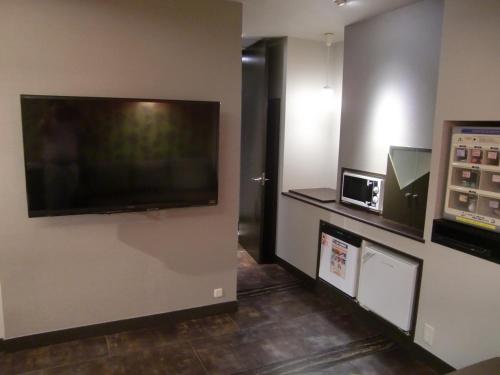 a room with a large flat screen tv on a wall at Hotel GOLF Nirasaki (Adult Only) in Nirasaki