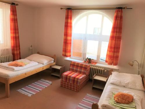 a bedroom with two beds and a window at Hostel Bernarda Bolzana in Tábor