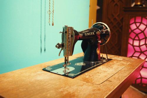 a sewing machine sitting on top of a wooden table at Hotel Ney in Konya