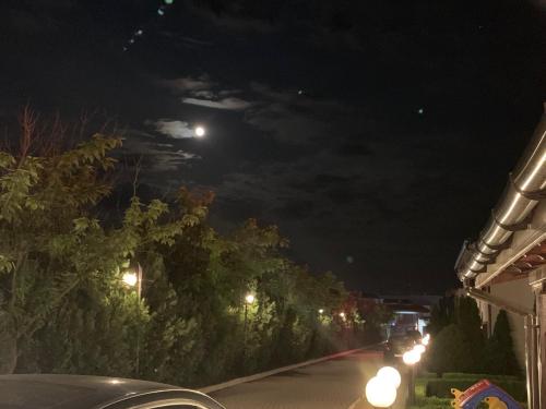 a street at night with the moon in the sky at PANTELI APART HOUSE in Aheloy
