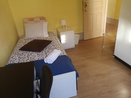 a bedroom with a bed with a laptop on it at Guesthouse Monsanto in Porto