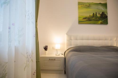 a bedroom with a bed and a picture on the wall at SUNNY NOVEMBER in Braşov