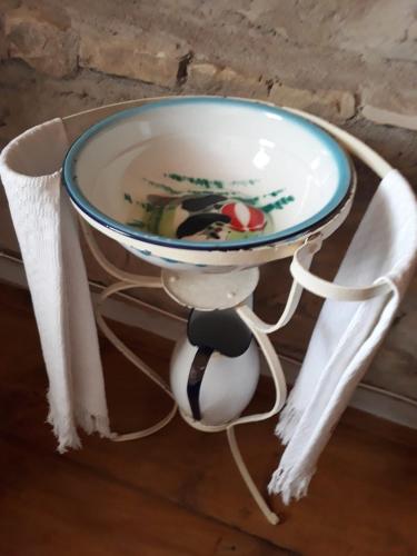 a bowl on a table with a soccer ball on it at Casa museo "Sa domu de ziu Antoneddu" in Tuili