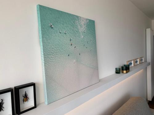 a large painting on a wall in a living room at Seashore Beach View in Koksijde