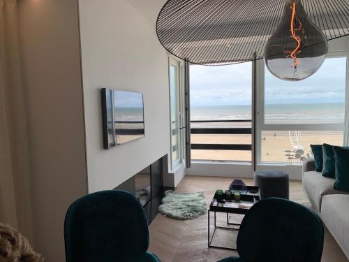 a living room with a view of the beach at Seashore Beach View in Koksijde