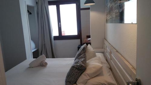 a bedroom with a bed and a window at Hostal Ibiza in Ibiza Town