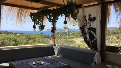 a room with a large window with a view of the ocean at L'Olla in Cala Ratjada