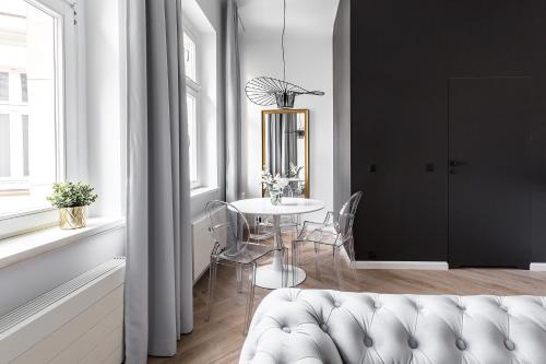 a living room with a table and a white couch at Homewell Boutique Apartments in Poznań
