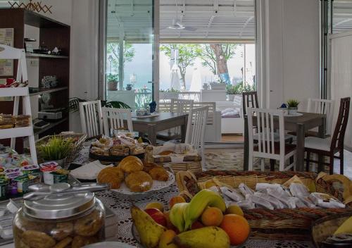 a table with many baskets of fruit on it at Hotel Everest - Bar e Ristorante in Gabicce Mare
