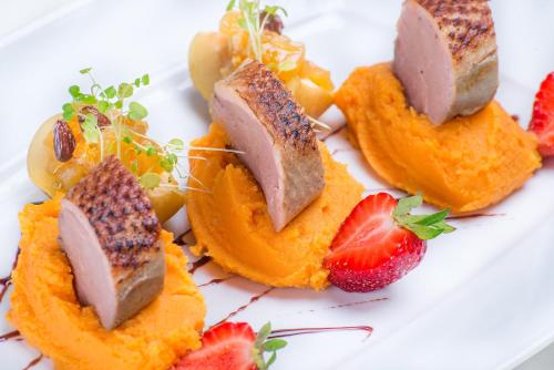 a plate of food with fruit on a white plate at Hotel Kazimierzówka in Kazimierz Dolny