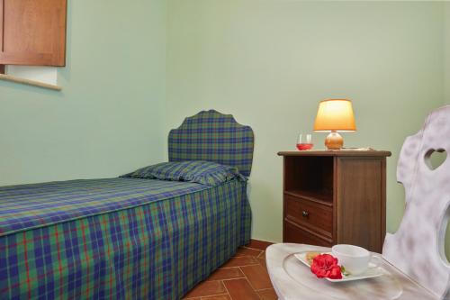 a bedroom with a bed and a table with a plate of food at La Coppa in Asciano