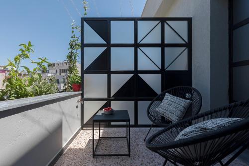 a balcony with two chairs and a table at Athenian Lofts in Athens