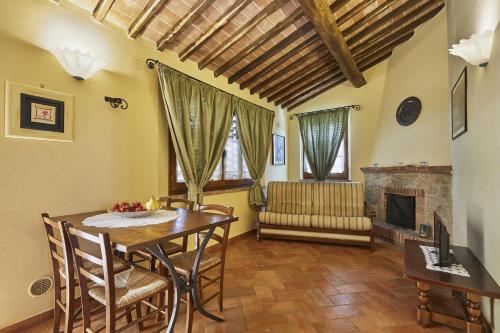 a dining room with a table and a fireplace at La Coppa in Asciano