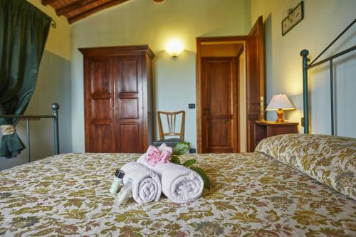 a hotel room with a bed with towels on it at La Coppa in Asciano