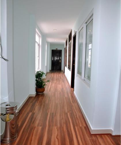 an empty hallway with wooden floors and white walls at Thai Binh II Hotel in Hue