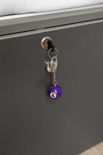 a doorhandle with a purple bead with a face on it at Freinest Wien in Vienna