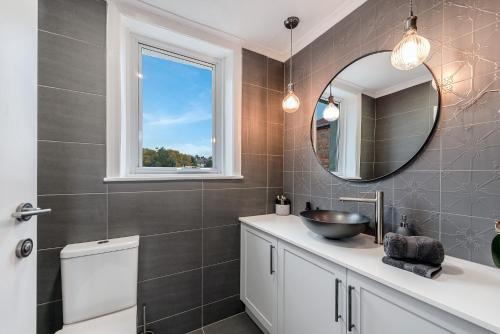 a bathroom with a sink and a mirror at City Retreat Hobart in Hobart