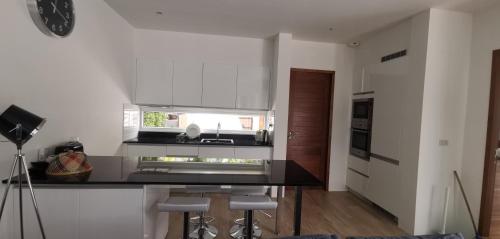 a kitchen with white walls and a black counter top at Villa Kamala close to the beach in Kamala Beach