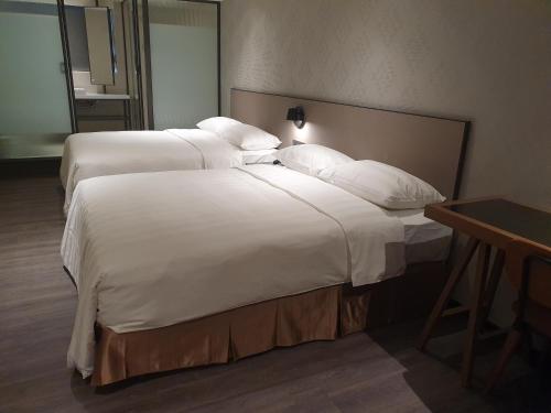 Ένα ή περισσότερα κρεβάτια σε δωμάτιο στο City Suites - Taoyuan Station