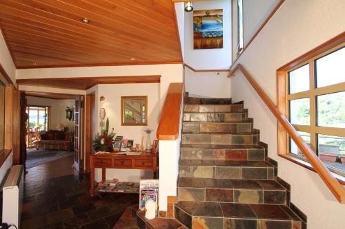a staircase in a home with a wooden ceiling at Chalet Romantica in Paihia