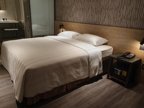 Ένα ή περισσότερα κρεβάτια σε δωμάτιο στο City Suites - Taoyuan Station