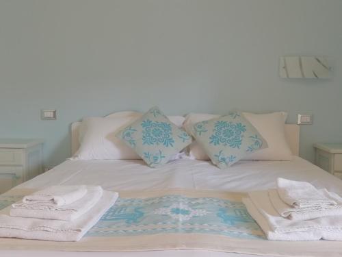 a bed with towels and pillows on it at Sardinia for you in Oristano