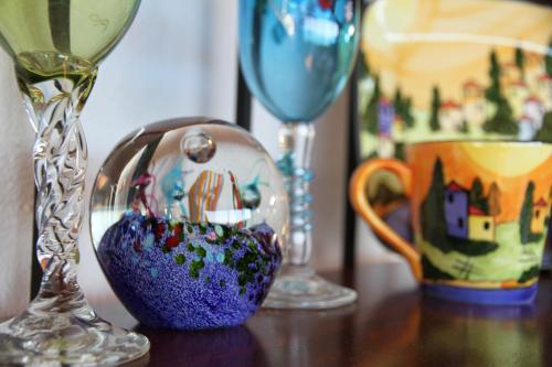a glass vase sitting on a table next to two wine glasses at Chalet Romantica in Paihia