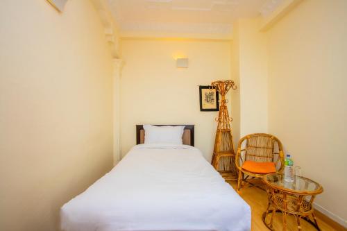 a bedroom with a bed and a table and a chair at Welcome Heritage Inn in Bhaktapur