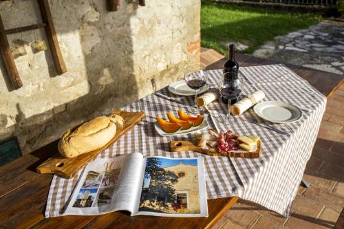a picnic table with a book and a plate of food at La Coppa in Asciano