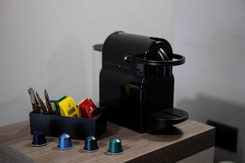 a desk with a coffee maker and a holder with pens at G&G FIRENZE SUITES in Florence