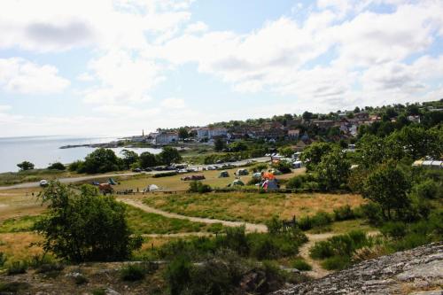 a view of a town and the ocean from a hill at NORDVIG bed & breakfast in Sandvig