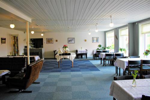 a dining room with tables and chairs in a restaurant at NORDVIG bed & breakfast in Sandvig