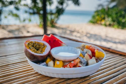 a bowl of food on a table near the beach at SunBoo Beach Bungalows in Koh Rong Sanloem