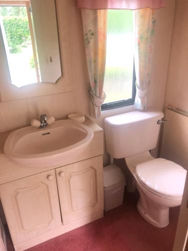 a bathroom with a sink and a toilet at Summer beach house in Saulkrasti