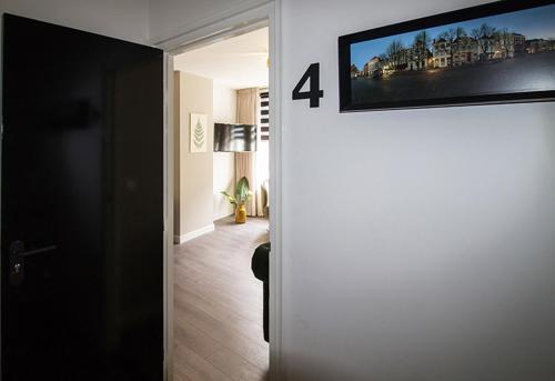 a living room with a television on the wall at Citystays Deventer in Deventer
