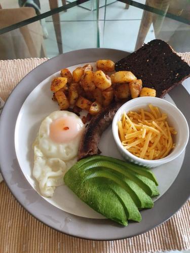 a plate of breakfast food with eggs sausage and a pickle at The Noble Ant in George