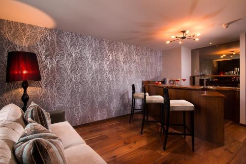 a living room with a couch and a bar at The Twelve Hotel in Barna
