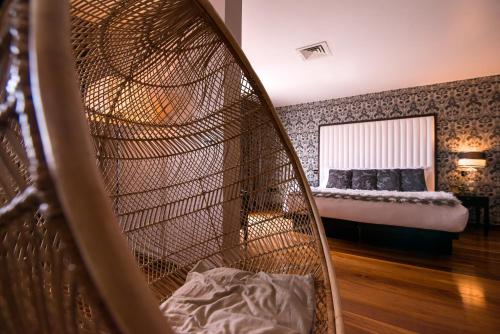 a room with a large bird cage with a bed at The Twelve Hotel in Barna