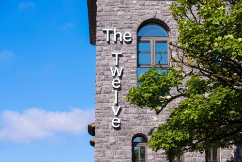 a building with a sign on the side of it at The Twelve Hotel in Barna
