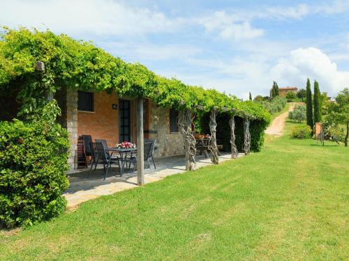 a house with a table and chairs in a yard at Holiday Home Casa dell'Orto by Interhome in Case Bardi