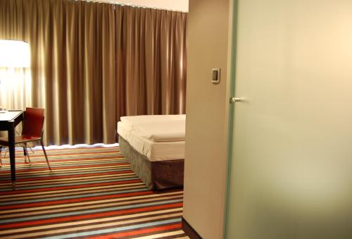 Postel nebo postele na pokoji v ubytování Silver Hotel & Gokart Center