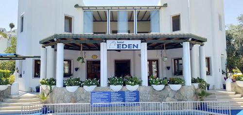 a white building with a sign in front of it at Eden Hotel in Bodrum City
