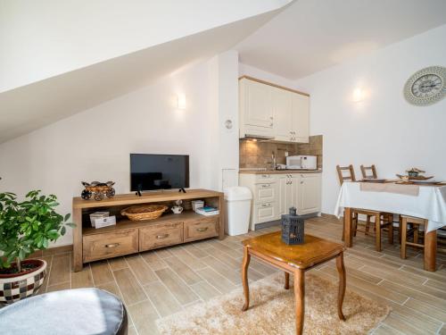 a living room with a kitchen and a table at Apartment Oltari-2 by Interhome in Biljevine