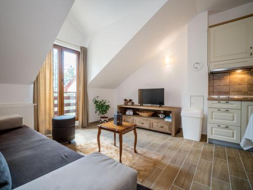 a living room with a couch and a tv at Apartment Oltari-2 by Interhome in Biljevine
