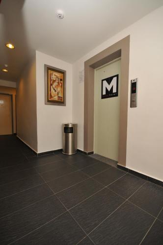 a hallway of an office with a sign on the wall at M Design Hotel @ Pandan Indah in Kuala Lumpur