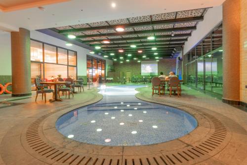 a building with a pool in the middle of the floor at Makeen Homes by Warwick Hotel in Riyadh