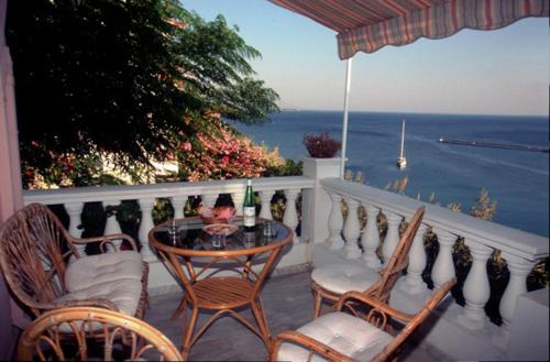 a balcony with a table and chairs and the ocean at Hera 2 in Pythagoreio