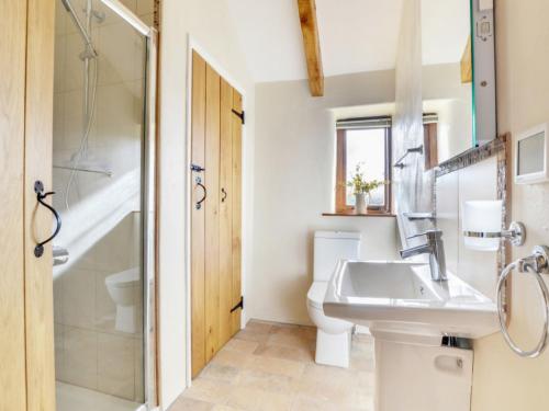 a bathroom with a sink and a shower and a toilet at Holiday Home Crow by Interhome in Witheridge