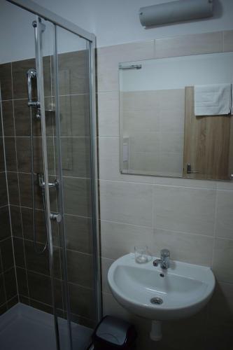 a bathroom with a sink and a shower at MEANDER THERMAL & SKI REZORT ORAVICE in Oravice