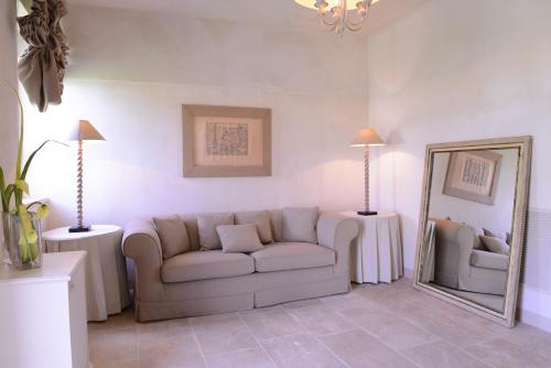 a living room with a couch and a mirror at Castello Camemi in Vizzini